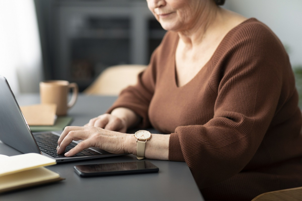 senior-woman-using-laptop-sitting-desk-living-room 2.jpg senior-woman-using-laptop-sitting-desk-living-room 2.jpg